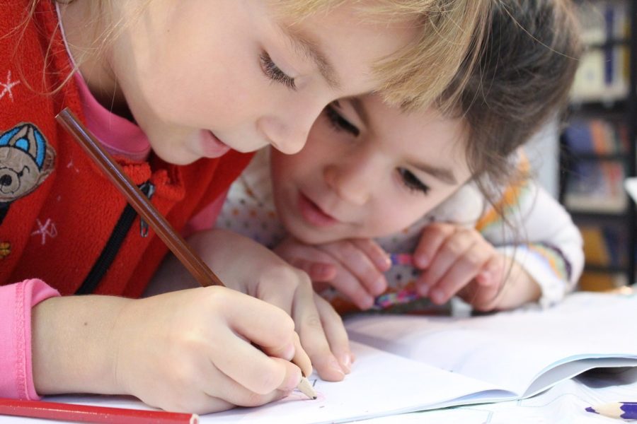 Two little girls drawing