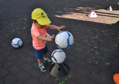 Little boy is playing with a ball in the nursery school